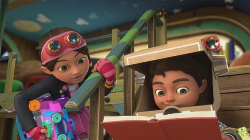 Rechte: KiKA/BBC/Boat Rocker Rights Inc. MMXVIII Bob zeigt Bitz seine große Entdeckung im Wüsten-Buch. Bitz hält ein Spielauto unter dem Arm und Bob blickt konzentriert ins Buch.