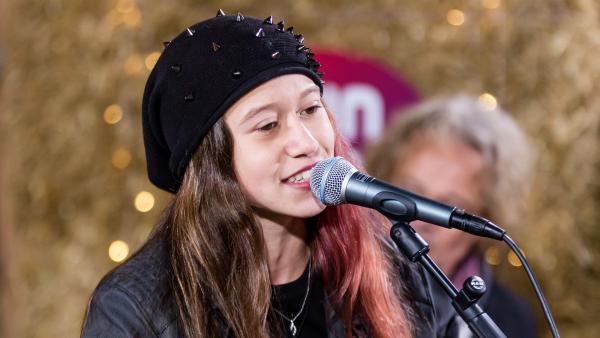 Die "Dein Song"-Kandidatin Sarah (14) eröffnet die Show des Halbfinales. Mit "Leise Worte werden laut" tritt sie vor die Jury. Ein kraftvoller Rocksong, mit dem sie es "rocken" will.