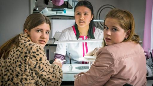 Im Nagelstudio | Rechte: NDR/Letterbox - Boris Laewen Lou und Pippa sitzen an einem Tisch im Nagelstudio, auf der anderen Seite des Tisches sitzt Mai.