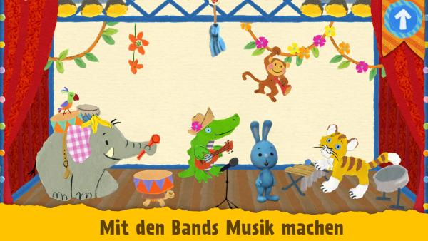 Bild zeigt blauen KiKANiNCHEN Hasen zusammen mit einem Elefant, Krokodil, Tiger und einem Affen. Sie musizieren zusammen.