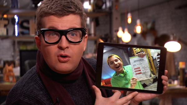 Tim verkleidet als Papa mit Foto auf dem Tablet