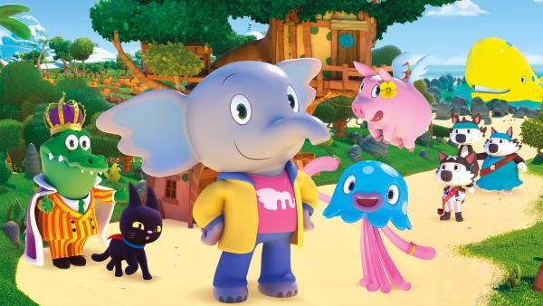Eine Gruppe Figuren aus der Animationsserie "Mamfie". Im der vorderen Bildmitte steht Elefant Mamfie auf zwei Beinen. Er trägt eine gelbe Jacke über einem rosefarbenen Shirt und eine blaue Hose.