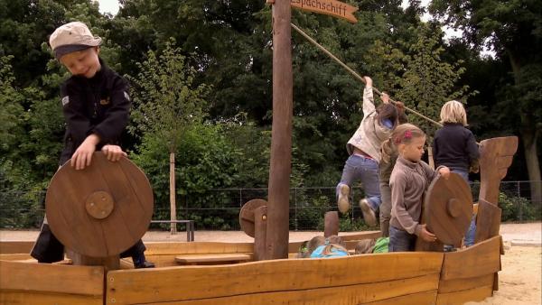 Die Kinder spielen auf dem Piratenschiff.
