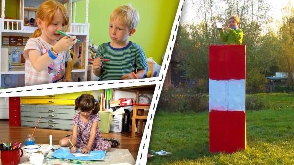 Kinder malen ein Bild. Ein Junge hat einen großen Leuchtturm aus Pappe gebastelt.