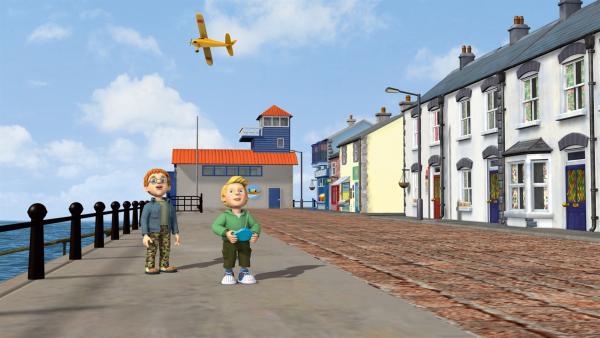 James hat ein Modellflugzeug, das er am Hafen fliegen lässt.