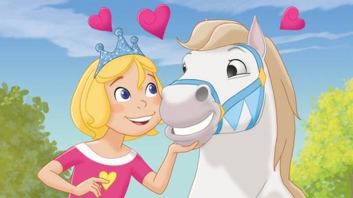 Rechte: KiKA/Studio 100 Prinzessin Emmy steht neben einem weißen Pferd und krault es mit der Hand. Die beiden schauen sich glücklich an. Über ihren Köpfen drei pinke Herzen. Im Hintergrund ein blauer Himmel und links und rechts Laubbäume.
