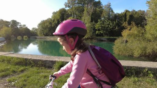 Rechte: ZDF/RAI Nika fährt mit dem Fahrrad am Ufer eines Flusses entlang.