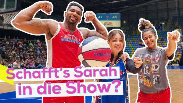 Dreier Gruppe mit Sarah in der Mitte. Sie hält einen Basketball in der einen Hand und zeigt mit der anderen darauf. Links neben ihr Team-Trainer Thunder und rechts neben ihr Sunshine. Aufschrift: Schafft's Sarah in die Show?