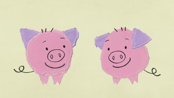 zwei rosa Schweine, die sich anlächeln