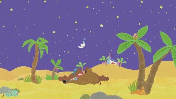 Kikaninchen und Christian liegen unter Sternenhimmel im kuscheligen Kamelbett.