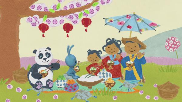 Kikaninchen, ein Pandabär und eine japanische Familie machen ein Picknick