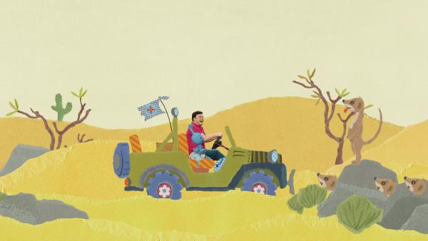 Kikaninchen und Christian fahren in der Wüste einen Jeep.