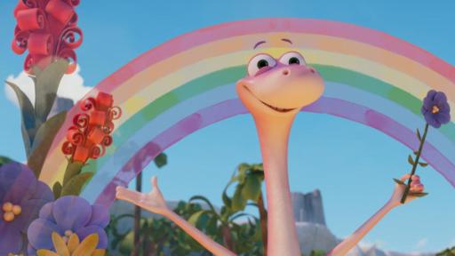 Der rosafarbene Dinosaurier Minus Drei hält eine Blume in der linken Hand und macht eine einladende Geste. Um ihn herum wachsen Blumen ins Bild - im Hintergrund ist ein farbenprächtiger Regenbogen zu sehen. Minus Drei strahlt über das ganze Gesicht.