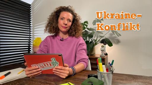 Gesa sitzt mit dem neuneinhalb-Tablet am Schreibtisch und schaut in die Kamera.